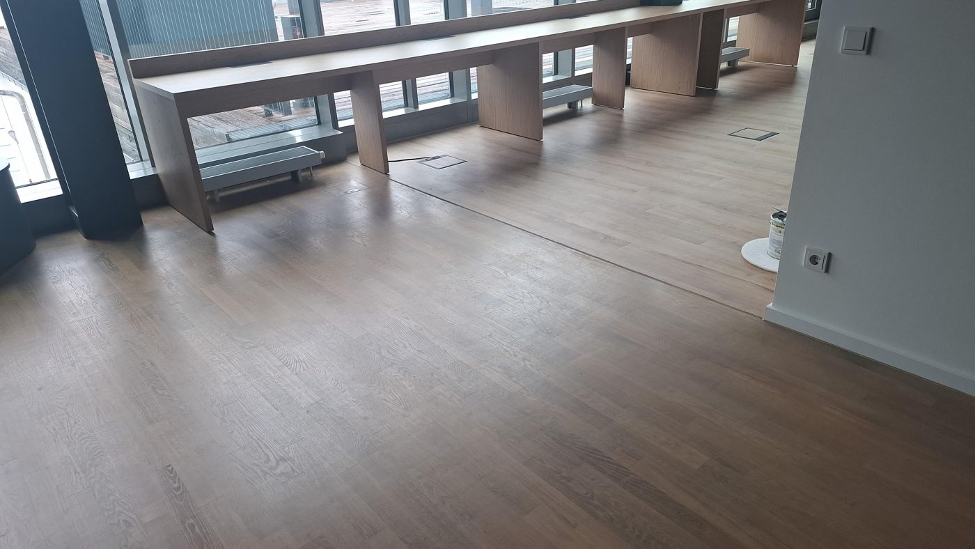 Uebergang von pigmentiertem geoeltem Parkett zu Designbelag im Buero